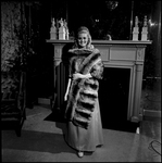 Woman Modeling Chinchilla Fur Coat in Front of Fireplace, A by George Skip Gandy IV