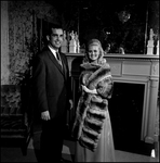 Woman Modeling Chinchilla Fur Coat with Man in Front of Fireplace, A by George Skip Gandy IV