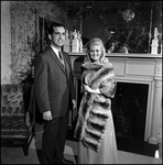 Woman Modeling Chinchilla Fur Coat with Man in Front of Fireplace, C by George Skip Gandy IV