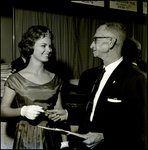 Man handing a Gift to a Woman at Florida Chiropractic Association Convention, Tampa, Florida, A by George Skip Gandy IV