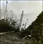 Cargo Ship Clearing Debris From Port Using Cranes, B by George Skip Gandy IV