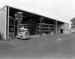 Employees Using a Forklift in a Warehouse, A by George Skip Gandy IV