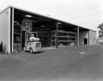 Employees Using a Forklift in a Warehouse, B by George Skip Gandy IV