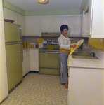 Woman Working in a Kitchen, Tampa, Florida by George Skip Gandy IV