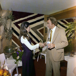 Two Attendees Shake Hands at a Cosmopolitan Realty and Investment Corp. Event by George Skip Gandy IV