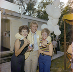 Three Attendees Pose for a Photo at a Cosmopolitan Realty and Investment Corp. Event by George Skip Gandy IV