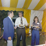 Three Attendees Socialize by a Refreshment Area During a Cosmopolitan Realty and Investment Corp. Event by George Skip Gandy IV