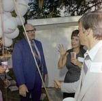 Three Attendees Socialize During a Cosmopolitan Realty and Investment Corp. Event by George Skip Gandy IV