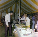 Two Attendees Socialize by a Refreshment Table During a Cosmopolitan Realty and Investment Corp. Event by George Skip Gandy IV