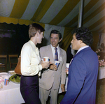 Dick Bloch and Two Attendees Socialize by a Refreshment Area During a Cosmopolitan Realty and Investment Corp. Event by George Skip Gandy IV