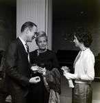 Three Attendees Socialize at a Maas Brothers Executives Reception for Imprevu by Coty by George Skip Gandy IV