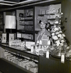 Nancy Adams Stands Behind a Coty Service Counter at a Maas Brothers Department Store by George Skip Gandy IV