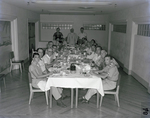 Large Group Dines at a Table by George Skip Gandy IV