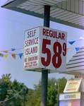 Self Service Station Sign Advertising the Cost of Fuel by George Skip Gandy IV