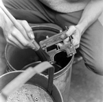 Person Cleaning Metal Parts, Tampa, Florida, A by George Skip Gandy IV