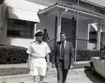 Ship Captain and Man Outside Eller & Company Building, Tampa, Florida, E by George Skip Gandy IV