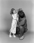 Portrait of Father and Daughter Playing with Stuffed Animal for Denton and French, B by Skip Gandy