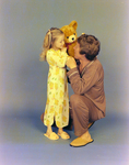 Portrait of Father and Daughter Playing with Stuffed Animal for Denton and French, D by Skip Gandy