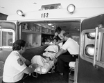 Paramedics Helping Woman Ambulance, D by Skip Gandy