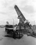 E-Z Way Products Metal Tower is Lifted Off Truck, A by Skip Gandy