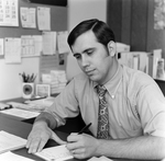 Man in Paisley Tie Writing at Desk, Tampa, Florida, B by George Skip Gandy IV