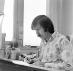 Man in Floral Shirt Drawing at Desk, Tampa, Florida, A by George Skip Gandy IV