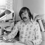 Man in Floral Shirt Drawing at Desk, Tampa, Florida, D by George Skip Gandy IV