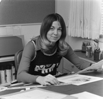 Woman Sitting at Desk with Design Work, Tampa, Florida, A by George Skip Gandy IV