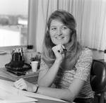 Woman Holding Paintbrush at Desk, Tampa, Florida by George Skip Gandy IV