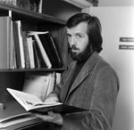 Man Holding Book in Office Library, Tampa, Florida, B by George Skip Gandy IV