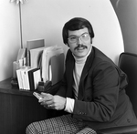 Man with Glasses at Desk in Tampa, Florida, B by George Skip Gandy IV