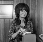 Woman Using Rolodex at Desk, Tampa, Florida, A by George Skip Gandy IV