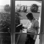 Man Using Microsonic Leak Detector on Window, I by George Skip Gandy IV