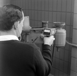 Man Using Microsonic Leak Detector on Industrial Equipment, A by George Skip Gandy IV