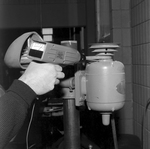 Technician Inspecting Industrial Equipment with Microsonic Leak Detector, A by George Skip Gandy IV