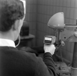 Man Using Microsonic Leak Detector on Industrial Equipment, C by George Skip Gandy IV