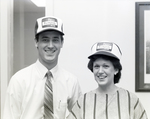 Two Employees Pose Wearing Company Hats, First Florida Bank Event, B by George Skip Gandy IV