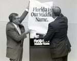 Two Employees Unveil First Florida Bank Sign by George Skip Gandy IV