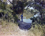 Man Standing on Bank, Florida by Skip Gandy