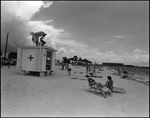 Lifeguard Looks to his Left as the Beachgoers Enjoy the Beach, Tampa, Florida by George Skip Gandy IV