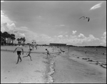 Lifeguard Walks Along Beach while Children Play, Tampa, Florida by George Skip Gandy IV