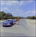 A Man Stands Outside His Car with a Sign Reading Chapman Contracting Company, Tampa, Florida by George Skip Gandy IV