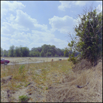 Scene of a Man in the Distance Crouching and Pointing, Tampa, Florida by George Skip Gandy IV