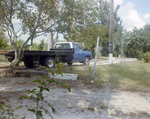 Blue Truck Travels Down Dirt Driveway in Tampa, Florida