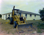 Backhoe beside House, B by George Skip Gandy IV