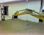 Backhoe Digging Trench beside House, A by George Skip Gandy IV