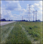 Electrical pylons next to a road, Amoco, Tampa, Florida, A by Skip Gandy