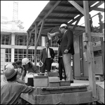 Man speaking to construction worker, C