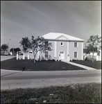 White Two-Story Home on Street Corner in Tampa, Florida, A by Skip Gandy