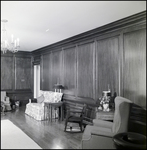 Wood-Paneled Sitting Room with Loveseat and Rocking Chair in Tampa, Florida, A by Skip Gandy